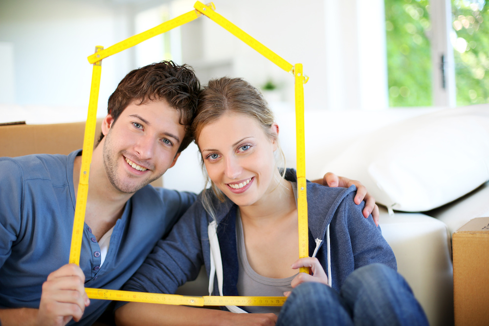 Portrait of happy young property owners